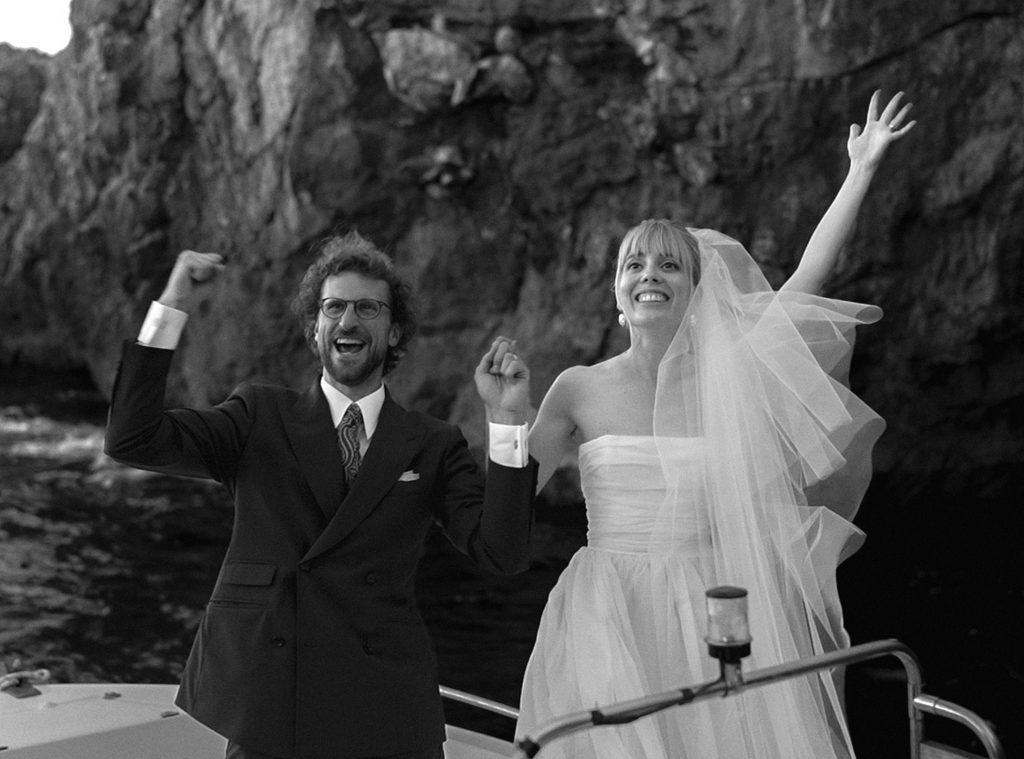 Bride and groom on a boat during their destination wedding in Puglia, Italy